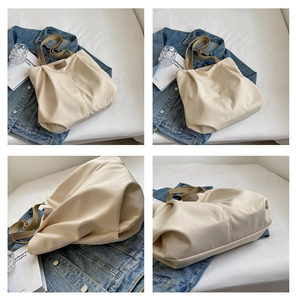 Macro view of cream canvas tote bag with brown handles and elegant folded texture
