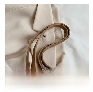 Close-up of premium brown leather tote bag straps with detailed stitching and soft texture