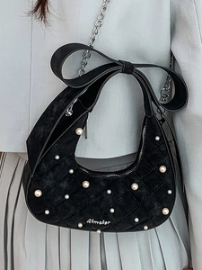 Black suede crescent shoulder bag with quilted texture, pearls and large bow strap