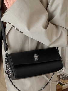 Minimalist black rectangular crossbody bag with pebble leather and silver twist lock