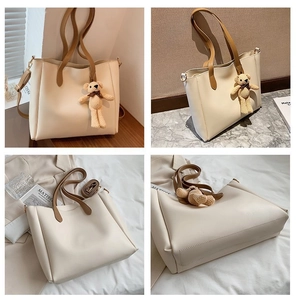 Detail views of beige tote bag with brown straps and cute knitted bear charm decor