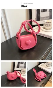 Detailed close-up of pink mini heart crossbody bag showing various angles and PU leather texture