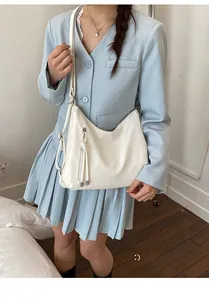 Detailed view of white soft PU leather tote bag with stylish fringe tassel and zipper