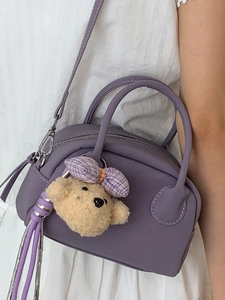 Stylish light purple bowling handbag for women with cute bear charm and crossbody strap