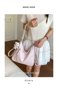 Detail of pink PU backpack with decorative fringe and cute white teddy bear charm