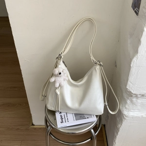 White minimalist PU leather hobo bag featuring a cute plush bear pendant and metal zipper