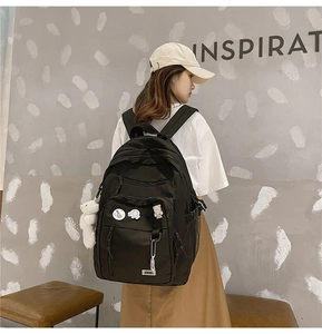High-capacity black backpack with multi-pocket design shown on model for school and travel