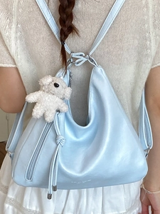 Light blue retro PU leather backpack with a cute plush charm for casual commuting