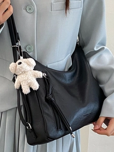 Minimalist black PU leather Hobo bag with plush bear charm and side zipper detail