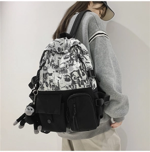 Harajuku style student backpack with black and white graffiti print and plush monkey charm