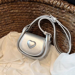 Mini silver heart-shaped crossbody bag for girls with shiny metallic PU leather finish