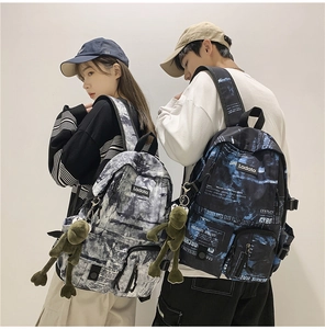 Tie-dye canvas backpack with brand logo and cute frog pendant for students in school