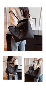 Detail of black nylon tote bag with leather straps and New York fashion logo