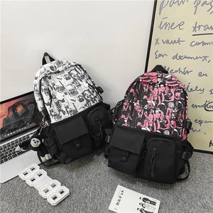 Detail of waterproof nylon backpacks with graffiti patterns and hanging monkey charms