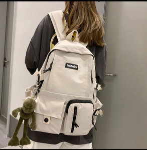 Cream white Harajuku style backpack with multiple pockets and a cute frog plush pendant