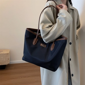 Large capacity color block tote bag in navy blue nylon with brown leather straps