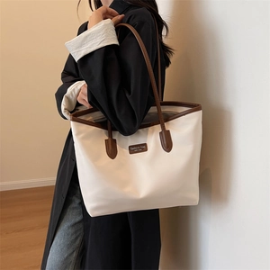 Chic off-white contrast tote bag with brown leather trim shown on a model for work commute