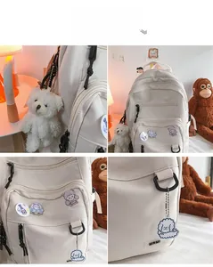 Detail view of cream white nylon backpack with multiple zippers and cute aesthetic badges