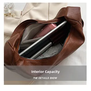 Macro view of the large capacity interior of this brown leather tote bag with daily items