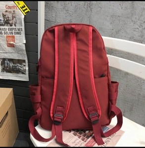 Detail view of the backpack back with anti-theft zipper pocket and padded shoulder straps