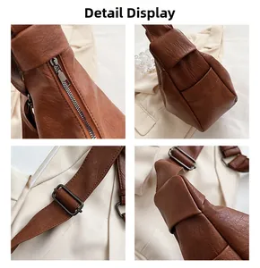 Close-up of caramel textured leather tote with metal buckles and detailed stitching