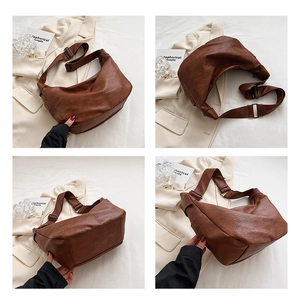 Detail view of the retro brown leather dumpling bag showing texture and strap adjustments