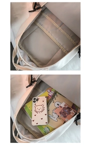 Internal view of cream backpack showing multi-layer compartments and large capacity storage