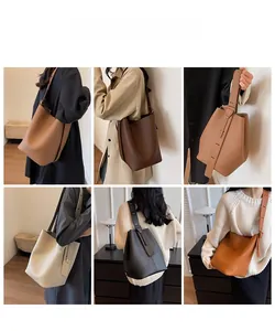 Modèle portant des sacs seaux en cuir minimalistes en six différentes couleurs élégantes