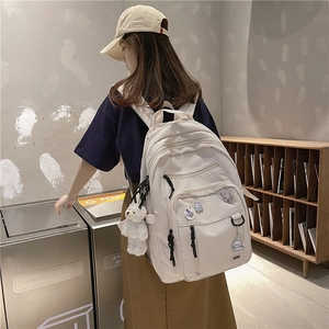 Minimalist white high-capacity school backpack for students with cute bear pendant charm