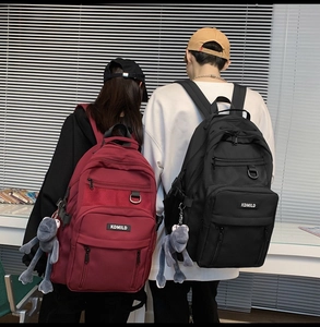 Detail view of multi-layer backpacks with side mesh pockets and cute plush pendants
