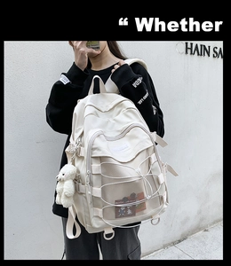 Detail view of cream canvas backpack featuring functional mesh pocket and lace-up design