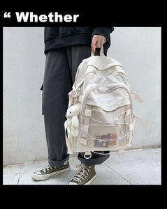 Creamy beige backpack with functional mesh pockets and a cute plush bear charm detail