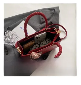 Detail show of large red crocodile pattern tote bag interior with multiple compartments