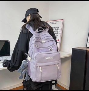 Side view of lavender nylon backpack with multi-layer pockets and mesh detailing