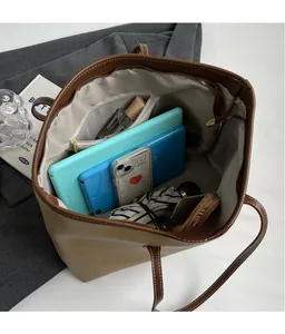 Macro shot showing large interior capacity of khaki tote bag with zipper pocket