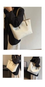 Detail of soft cream tote bag with brown trim and sturdy shoulder strap rivets
