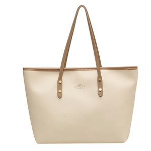 Large beige tote bag with brown handles and golden rivets for stylish women commuting