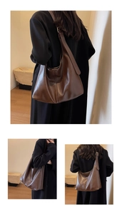 Detail view of large brown vintage hobo bag with textured leather and wide shoulder strap
