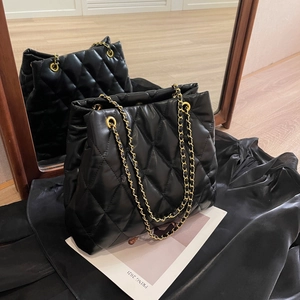 Classic black quilted tote bag with golden chain straps for elegant daily fashion style