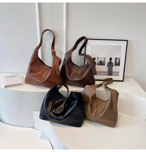 Detail view of large leather hobo bags in four colors with adjustable shoulder straps