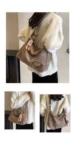 Close-up of brown plaid hobo shoulder bag with a cute rabbit plush pendant detail