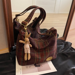 Vintage woolen plaid shoulder bag with a rabbit charm and elegant mirror reflection display