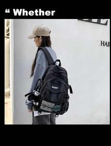Side view of black nylon backpack with decorative rope design and cute monkey pendant