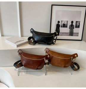 Detailed display of three PU leather chest bags with wide patterned ethnic straps