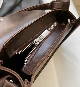 Close-up of the smooth silver metal zipper and fine leather edge oiling detail
