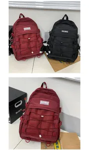 Detail of trendy school backpack with criss-cross elastic mesh and brand logo tag