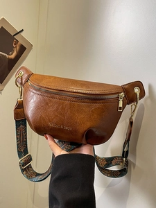 Retro brown leather crossbody bag with ethnic style strap and gold zipper detail