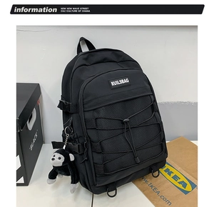 Detail view of black nylon school backpack with mesh pocket and elastic cross-ropes