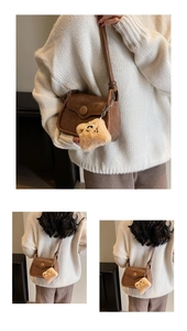 Brown vintage faux leather crossbody bag with a cute plush charm and flap closure