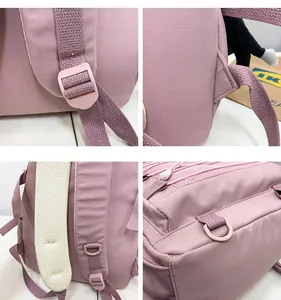 Detail view of pink backpack featuring adjustable plastic buckles and breathable mesh back